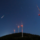 A meteor streaks across the sky during the Perseid meteor shower at a windmill farm near Bogdanci, Macedonia.